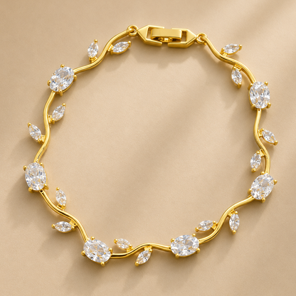 Gold bracelet with diamond-like stones on a beige background