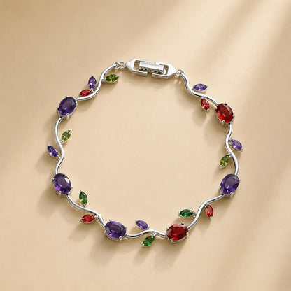 Silver bracelet with multicolored gemstones on a beige background