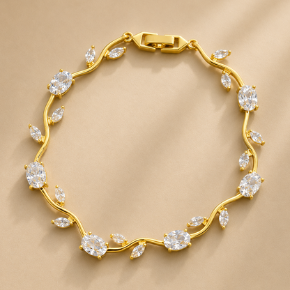Gold bracelet with diamond-like stones on a beige background