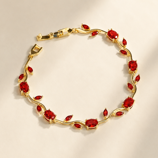 Gold bracelet with red gemstones on a beige background