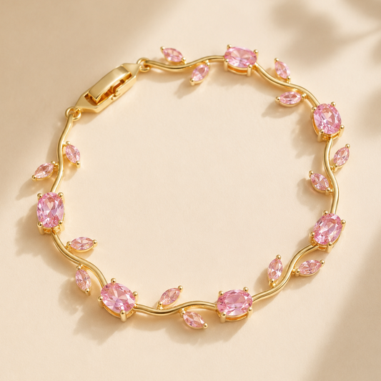 Gold bracelet with pink gemstones on a beige background