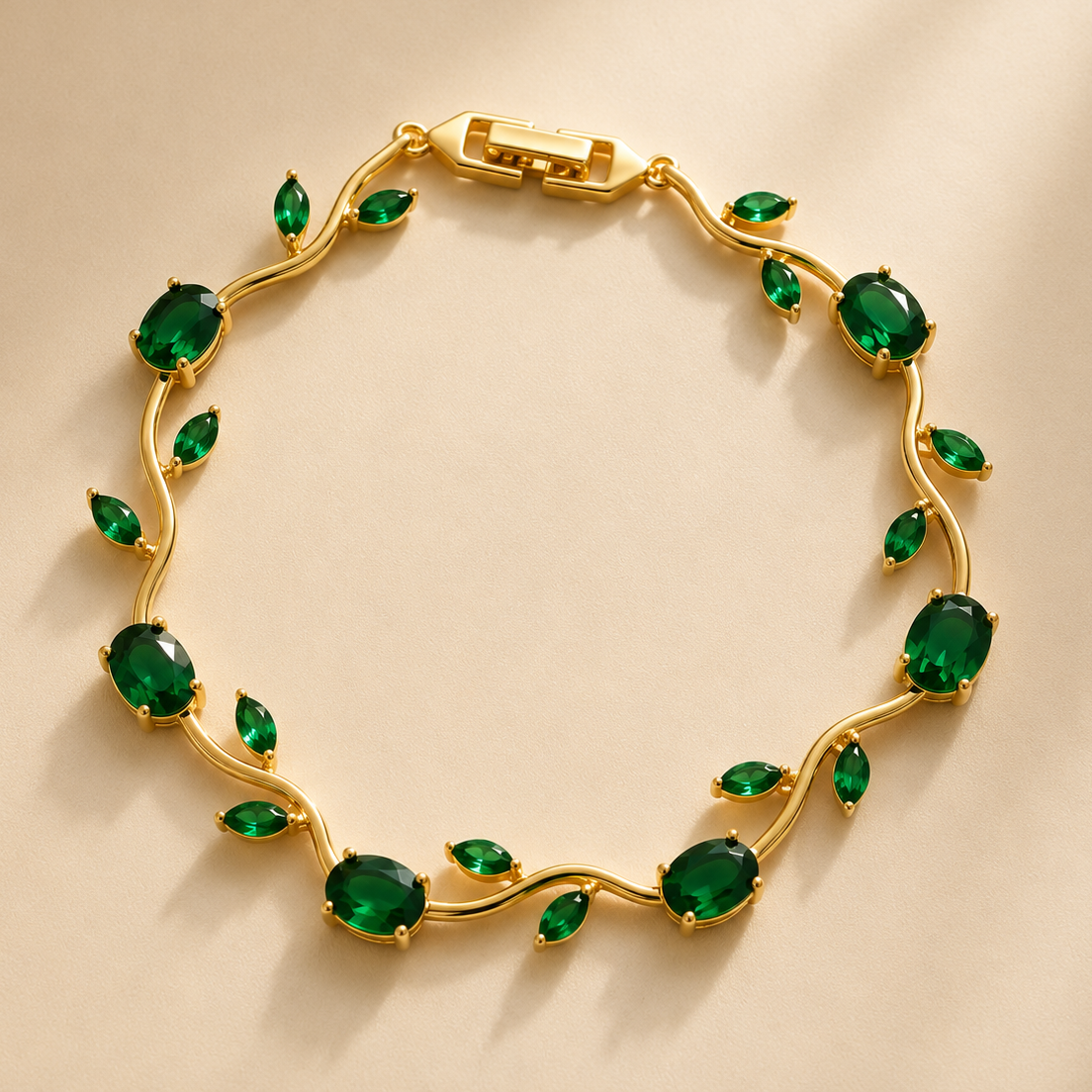 Gold bracelet with green gemstones on a beige background
